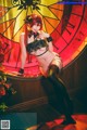 A woman in lingerie posing in front of a clock.