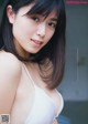 A woman in a white bra posing for a picture.